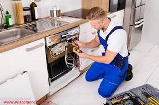 Electricians installing appliance